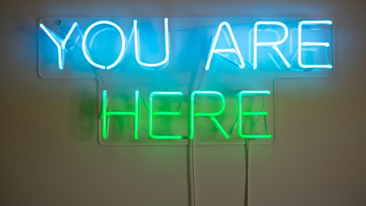 Neon light that says "You are here"