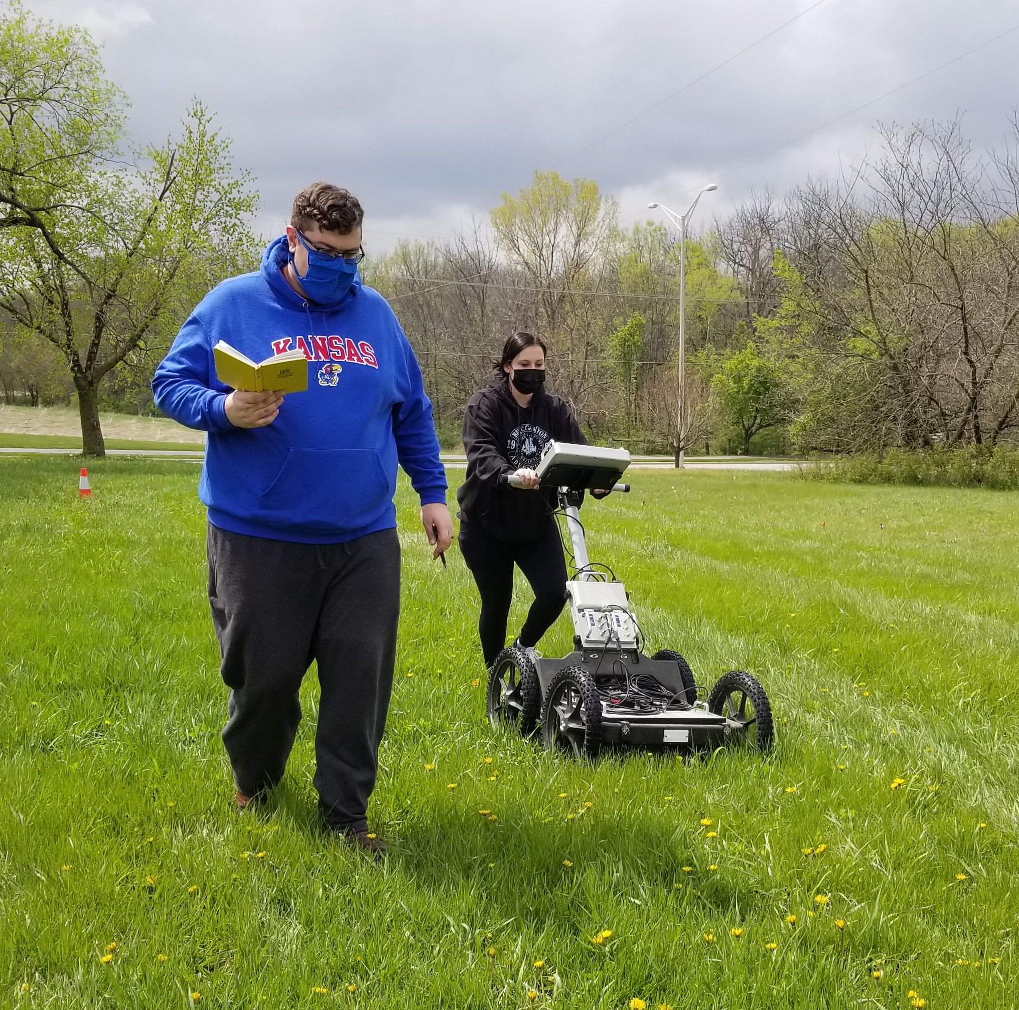 Will Swanson and Ali Vinke conduct a geophysical survey, using ground penetrating radar (GPR) to identify buried objects and geologic and hydrogeologic conditions in the ground’s subsurface during a workshop at the KU Edwards Campus on April 16.