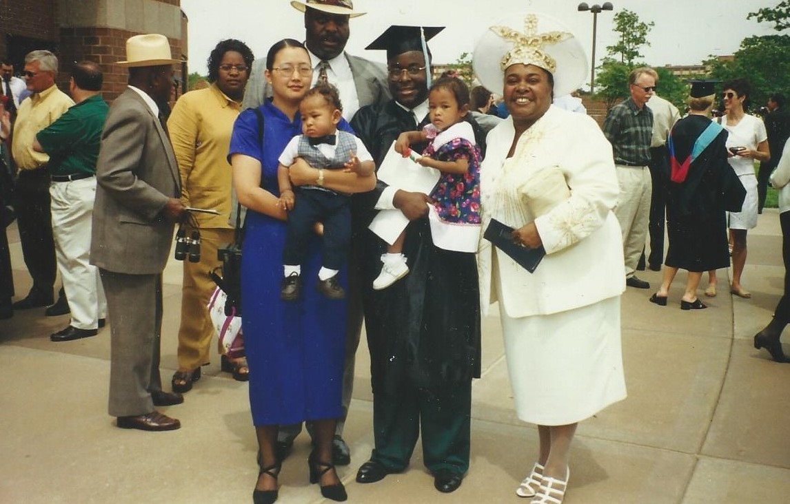 Jarius Jones (in commencement cap and gown) celebrates his KU Bachelor of Science in Education graduation with his family in May 1999