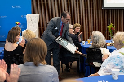 David Cook, KU Edwards Campus Vice Chancellor, presents artist Rita Blitt with a commemorative plaque honoring the gift of her artwork to the campus.