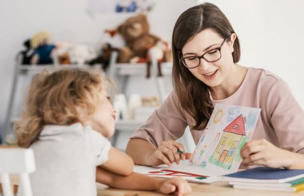 Adult looking at a drawing with a child