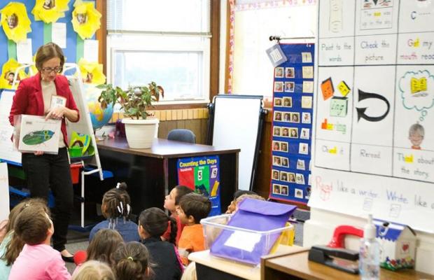 Teacher stands in front of her early childhood class 