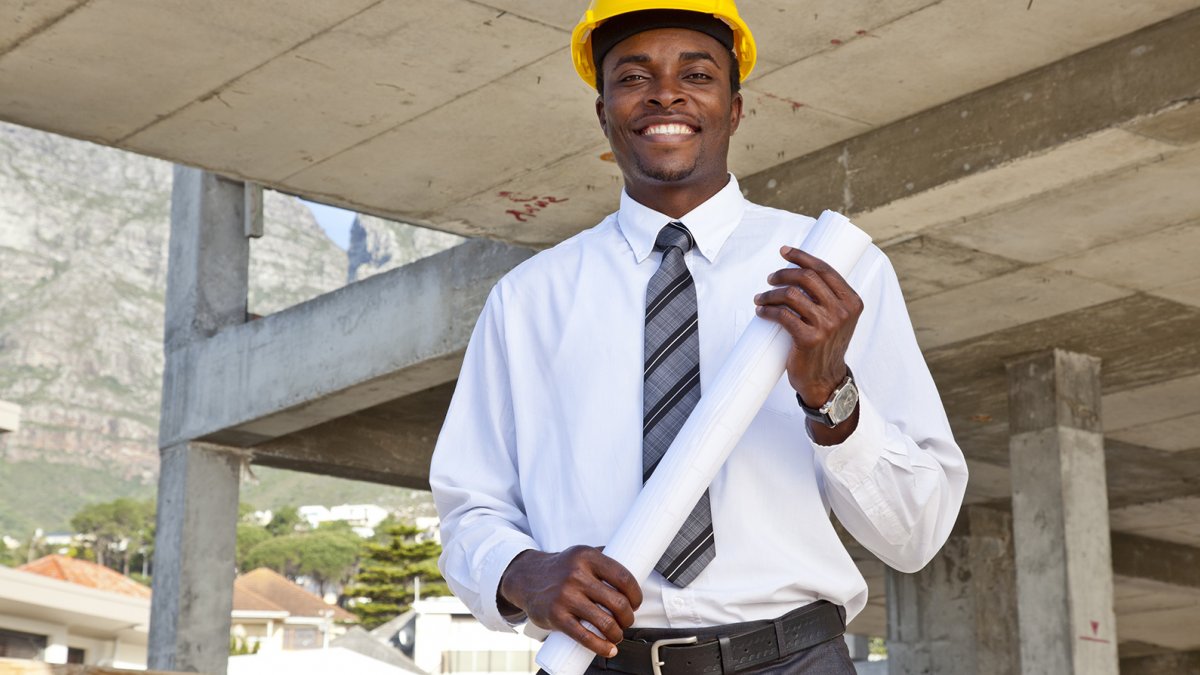 Adult in business attire and hard hat
