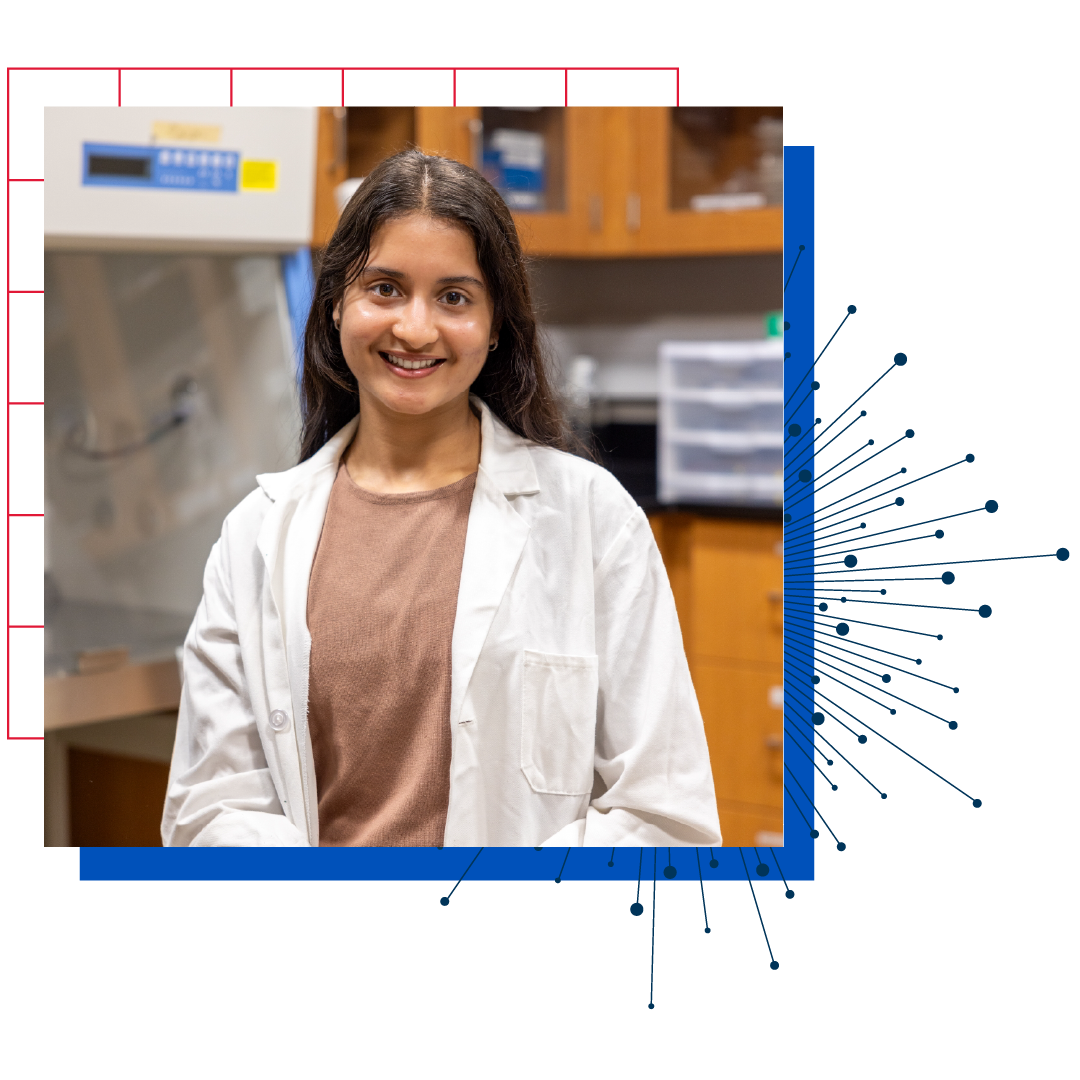 Kuljeet Kaur, a senior pursuing a biology career at the KU Edwards campus, stands in a vibrant outdoor setting.