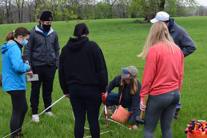 Blair Schneider, with the Kansas Geological Survey, works with students as they plot the ground before using using ground penetrating radar (GPR) to survey the area next to the KU Edwards Campus during an April 16 workshop.