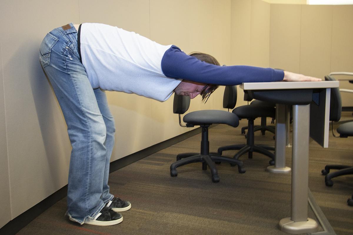 Adult stretching at desk