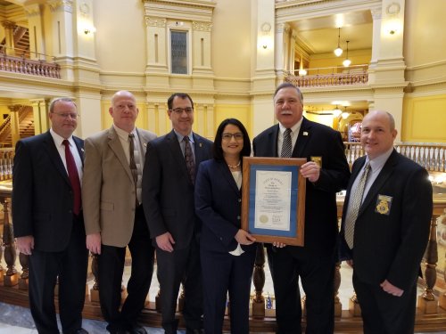 (From left) KLETC Associate Director Ron Gould; Assistant Director Tim Brant; KU Edwards Campus Vice Chancellor David Cook; Former KU Provost & Executive Vice Chancellor Neeli Bendapudi; KLETC Director Ed Pavey; and KLETC Associate Director Darin Beck celebrate the center's 50-year anniversary at the Kansas State Capitol in February 2018.