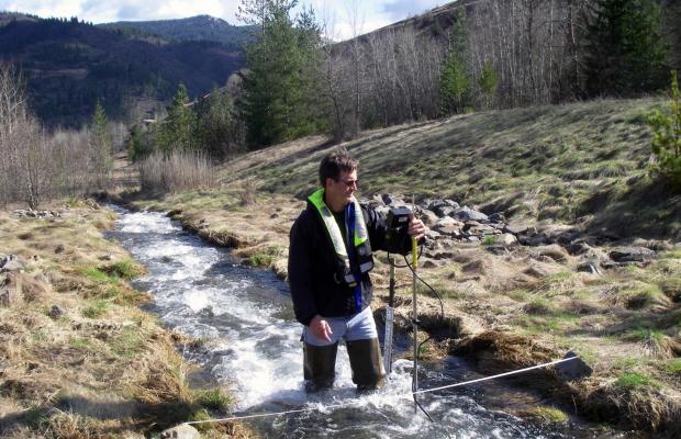 Man surveying in mountain stream