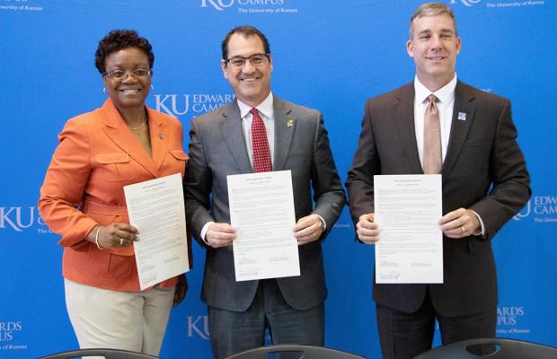 Independence School District Superintendent Dale Herl, Metropolitan Community College Chancellor Kimberly Beatty and KUEC Vice Chancellor David Cook celebrate a proclamation of intent for a new Degree in 3 partnership on May 6 at the KU Edwards Campus. High school students in ISD can earn a bachelor’s degree from KU in only three years.