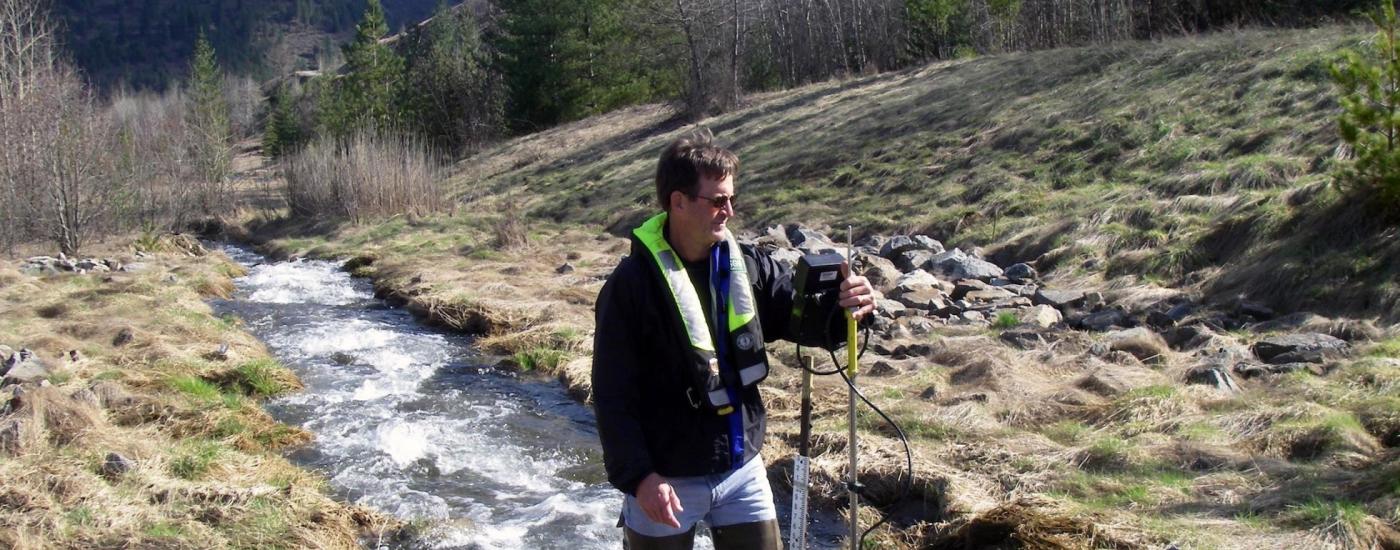 Man surveying in mountain stream